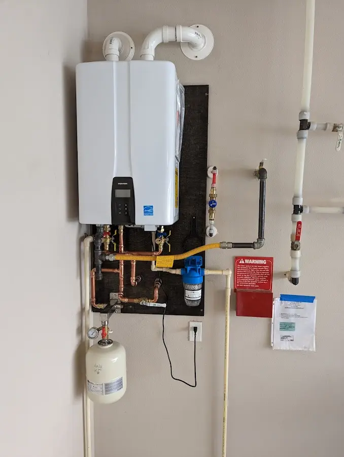 Professional plumber installing copper piping in a El Granada home